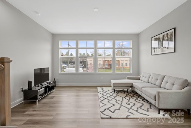 living room featuring wood finished floors and baseboards