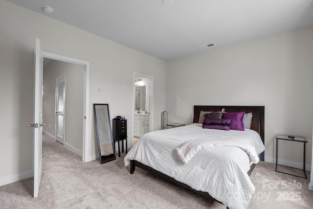 bedroom featuring carpet, connected bathroom, visible vents, and baseboards