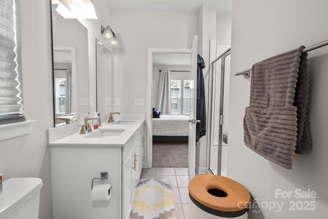 full bath featuring tile patterned floors, a sink, a shower stall, and ensuite bathroom