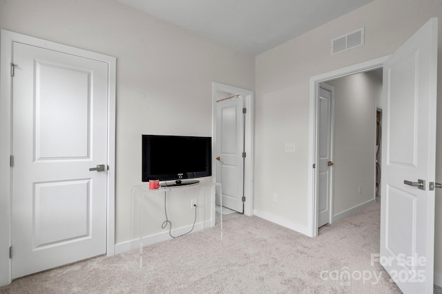 unfurnished bedroom featuring baseboards, visible vents, and carpet flooring