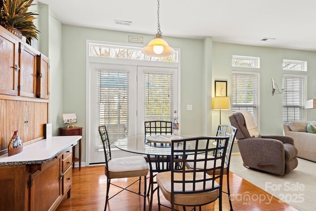 dining room featuring visible vents and wood finished floors