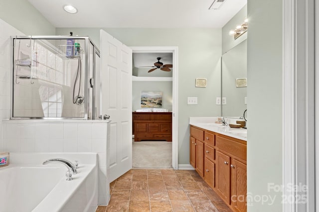 ensuite bathroom featuring double vanity, a stall shower, ceiling fan, a bath, and connected bathroom