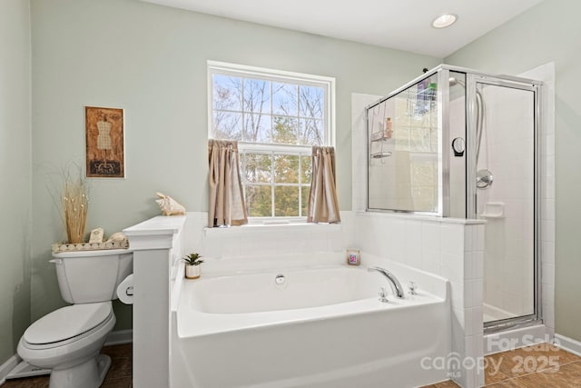 full bath with toilet, tile patterned floors, a bath, and a stall shower