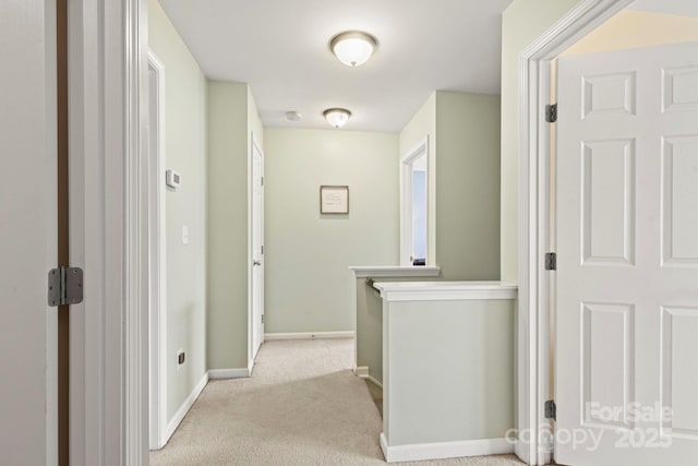 corridor with light colored carpet and baseboards