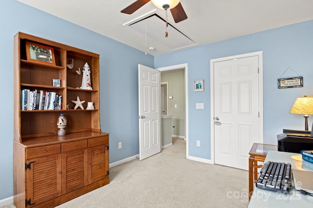 office with attic access, a ceiling fan, baseboards, and light carpet