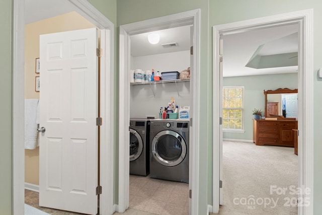 clothes washing area featuring laundry area, washer and dryer, and carpet