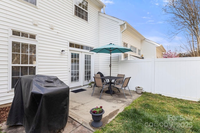 view of patio / terrace with fence and a grill