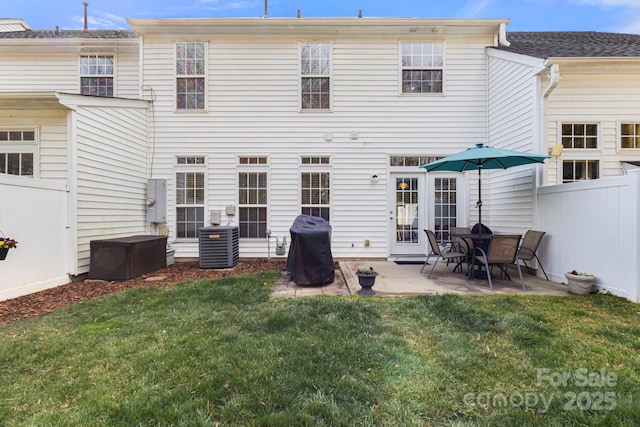 back of house with a patio area, a yard, fence, and central AC