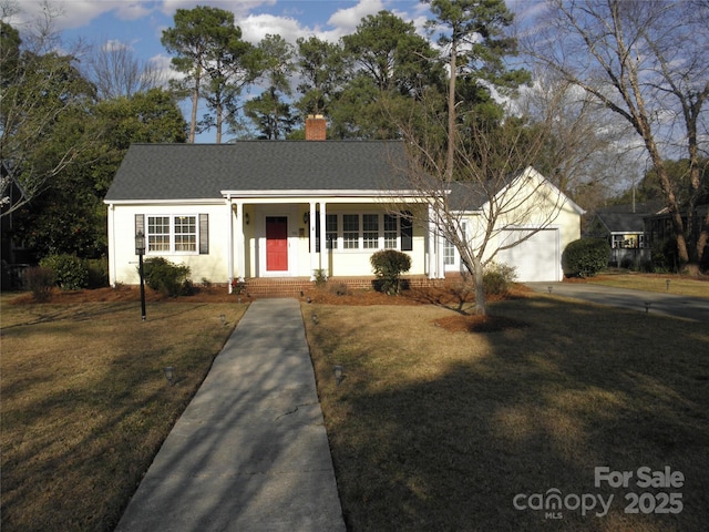 ranch-style house with a porch, a front yard, a chimney, and an attached garage