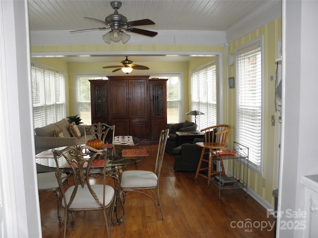 dining space featuring a healthy amount of sunlight, wood finished floors, and crown molding