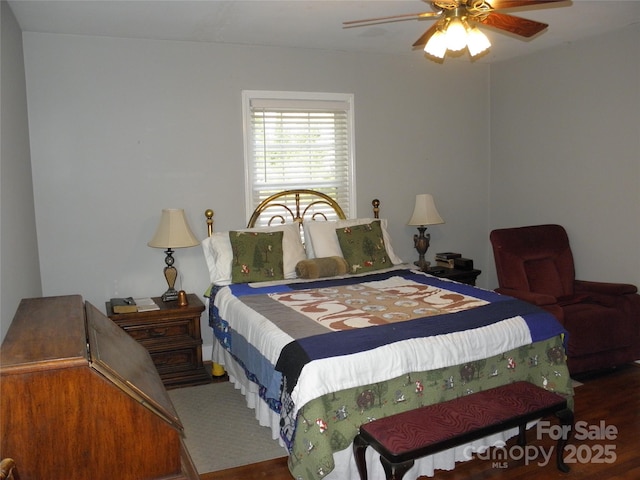 bedroom with a ceiling fan and wood finished floors