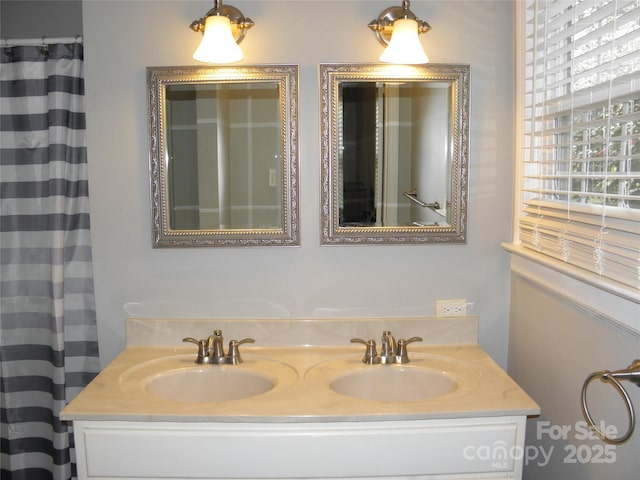 full bathroom with double vanity and a sink