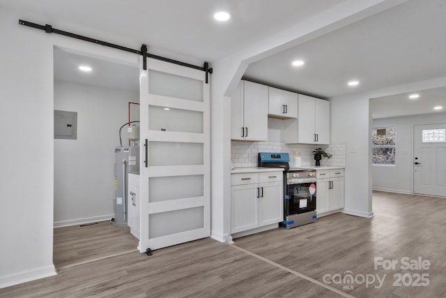 kitchen with white cabinets, water heater, light wood-type flooring, electric panel, and stainless steel range with electric stovetop