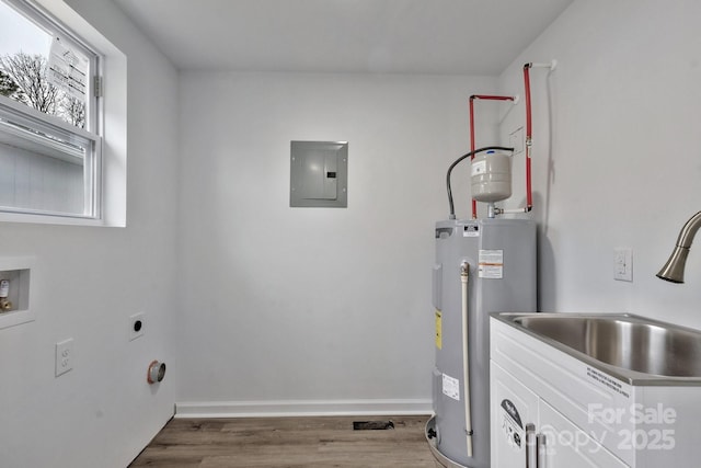 washroom featuring electric water heater, hookup for an electric dryer, laundry area, a sink, and electric panel