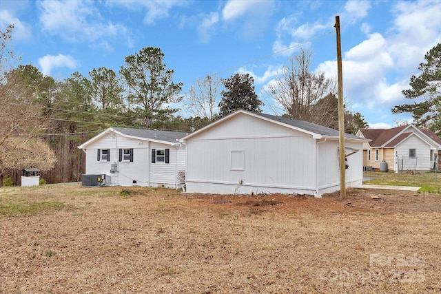 rear view of property with central AC