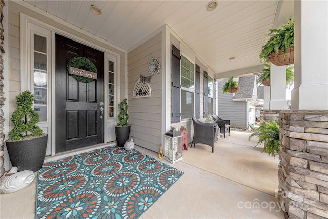 doorway to property featuring covered porch