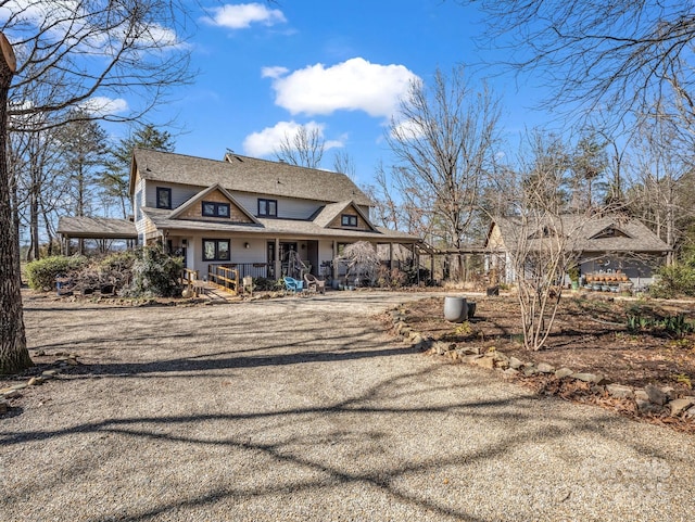 view of front of property featuring a carport and driveway