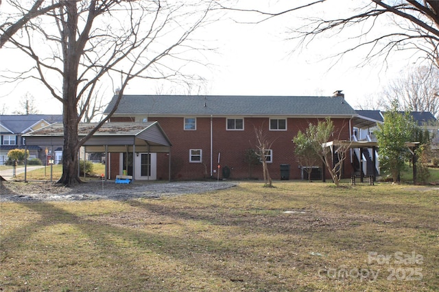 back of house with a yard, brick siding, and a chimney