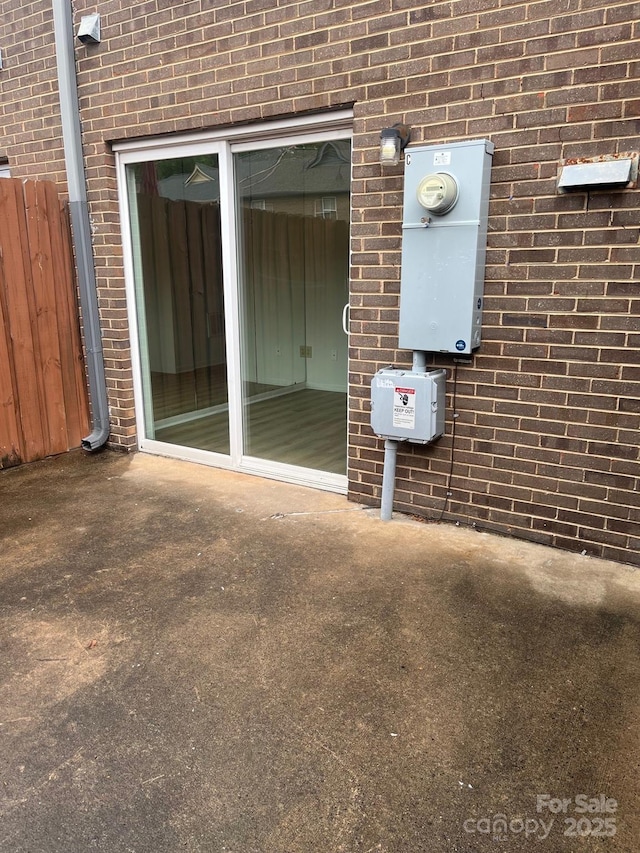 doorway to property featuring brick siding