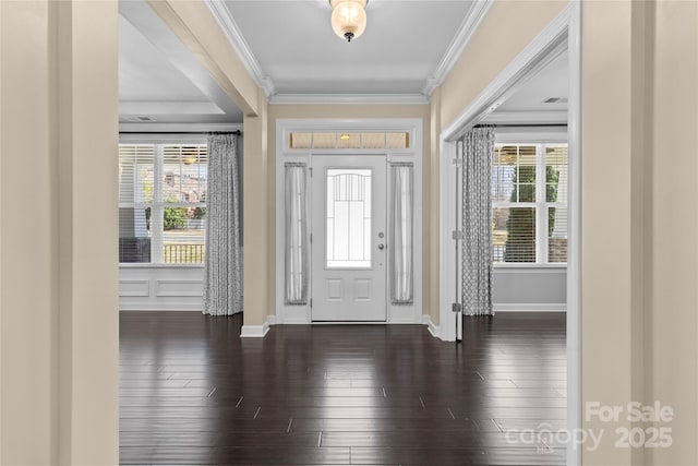 foyer entrance with a wealth of natural light, baseboards, ornamental molding, and dark wood-style flooring