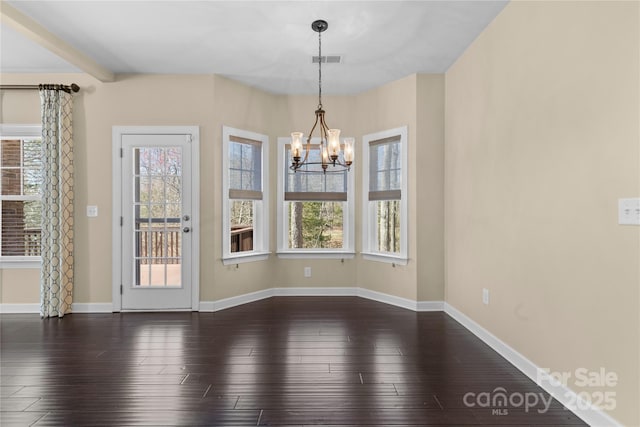 unfurnished dining area with a healthy amount of sunlight, dark wood-style floors, visible vents, and a chandelier