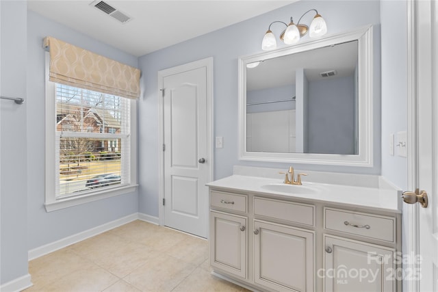 bathroom featuring tile patterned floors, visible vents, vanity, and baseboards