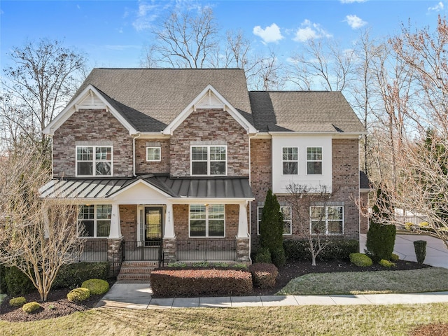 craftsman-style home featuring brick siding, a porch, and a shingled roof