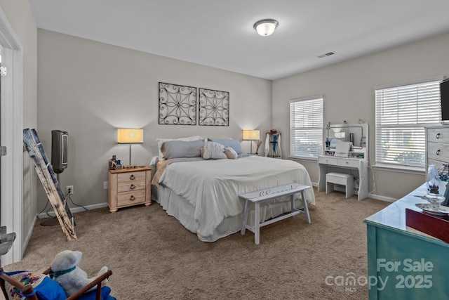 carpeted bedroom featuring visible vents and baseboards