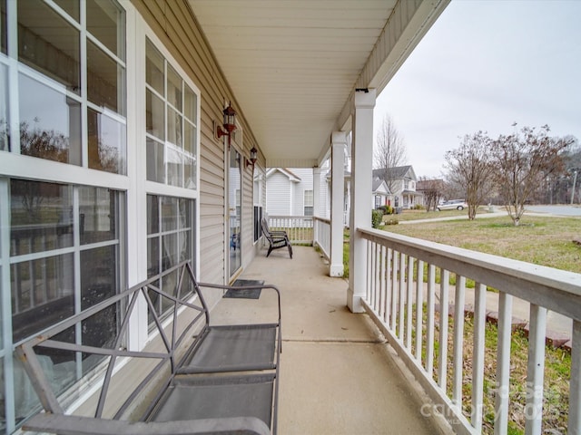 balcony with covered porch and a residential view