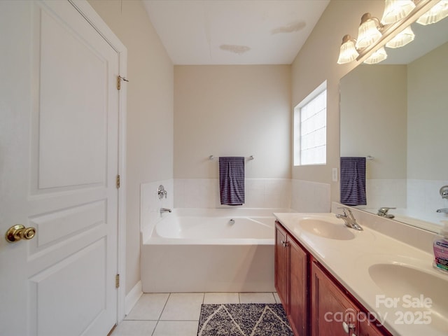 bathroom featuring double vanity, tile patterned floors, a garden tub, an inviting chandelier, and a sink