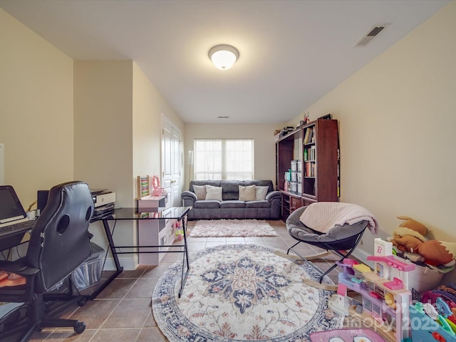 tiled home office with baseboards and visible vents