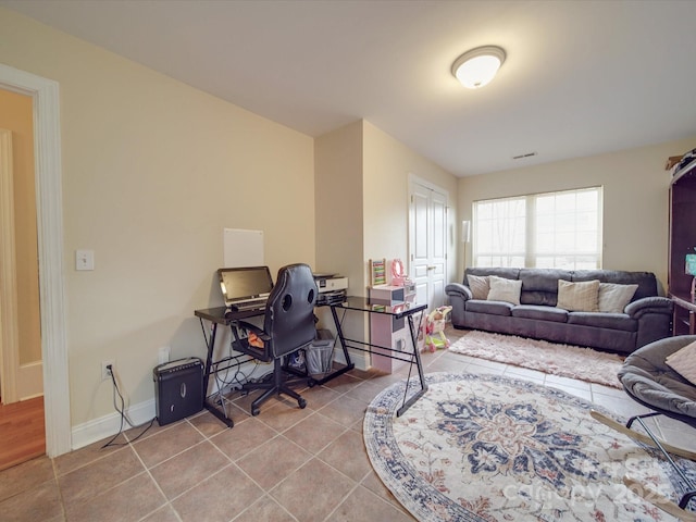 office area featuring tile patterned flooring, visible vents, and baseboards