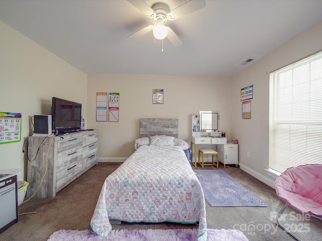 carpeted bedroom featuring baseboards, visible vents, and ceiling fan