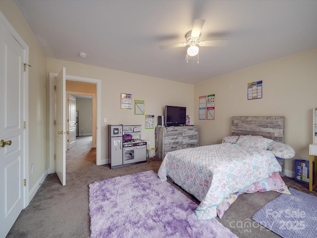 carpeted bedroom featuring ceiling fan and baseboards