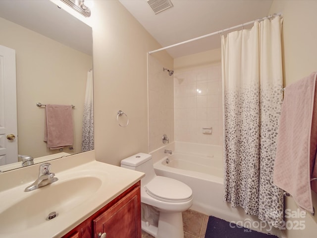 bathroom featuring shower / tub combo with curtain, visible vents, toilet, vanity, and tile patterned floors