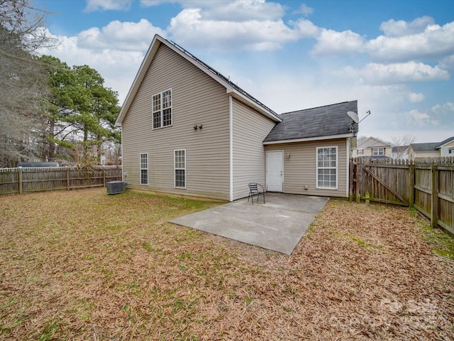 back of property featuring a patio area, a fenced backyard, central AC, and a yard