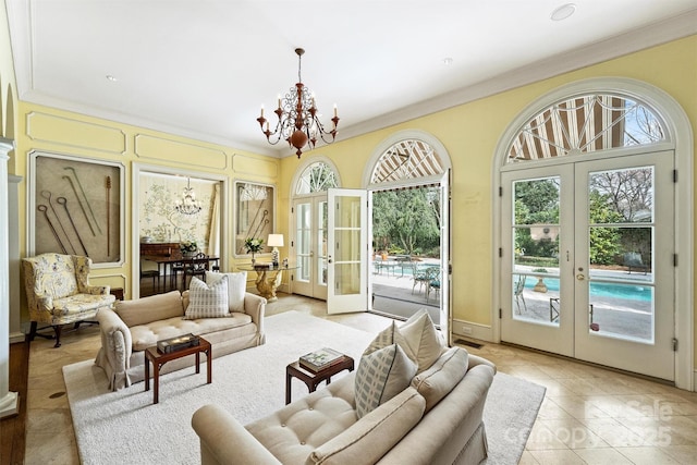 sunroom / solarium with french doors and a chandelier