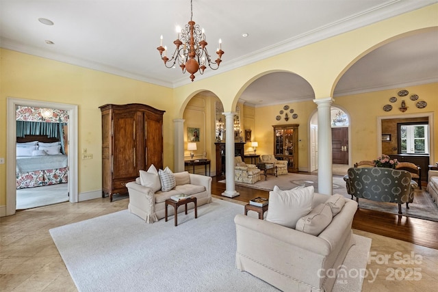 living area with decorative columns, arched walkways, and a chandelier