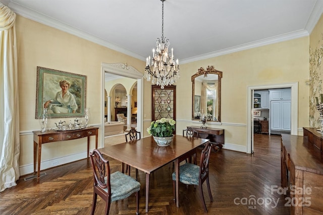 dining room featuring visible vents, ornamental molding, arched walkways, baseboards, and a chandelier