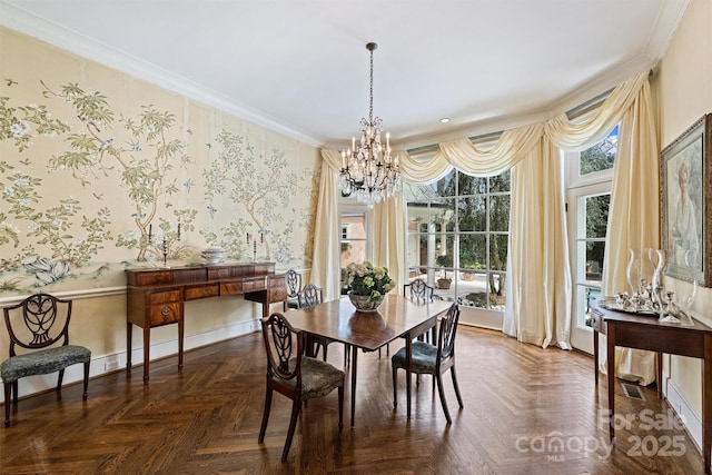 dining room with baseboards, wallpapered walls, crown molding, and an inviting chandelier