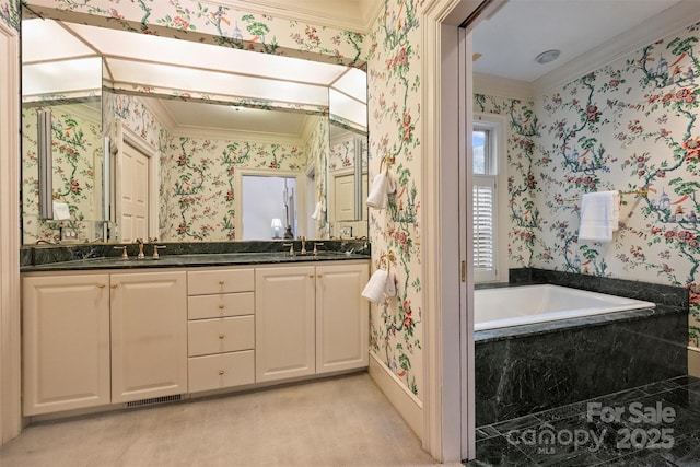 full bath with visible vents, a garden tub, a sink, wallpapered walls, and double vanity