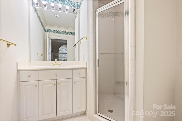 full bath featuring vanity, crown molding, and a stall shower