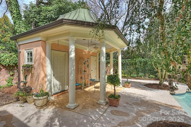 view of patio / terrace featuring an outbuilding, an outdoor pool, and ceiling fan