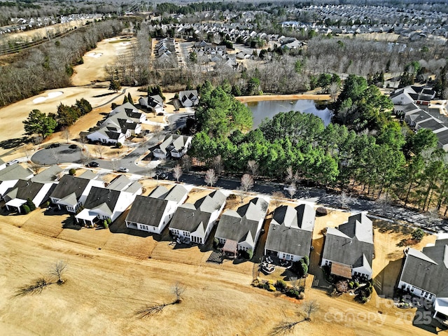 drone / aerial view featuring a residential view and a water view