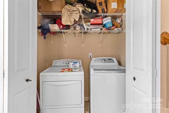 clothes washing area featuring washing machine and clothes dryer and laundry area