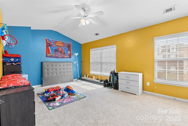 recreation room featuring vaulted ceiling, carpet flooring, visible vents, and ceiling fan