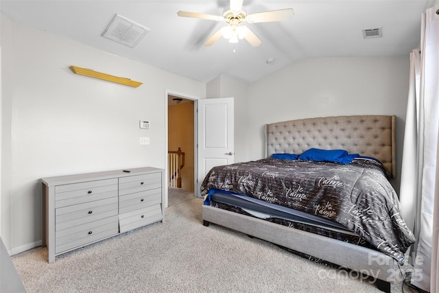 carpeted bedroom featuring visible vents, lofted ceiling, and a ceiling fan