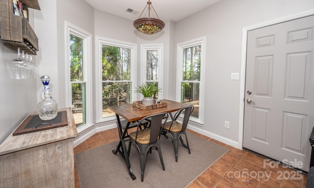 dining space featuring visible vents and baseboards