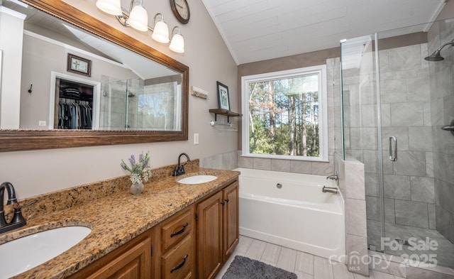 bathroom featuring a stall shower and a sink