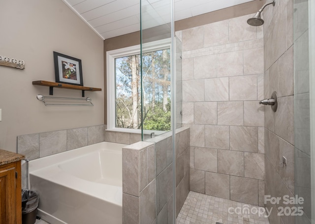 bathroom featuring a bath and tiled shower